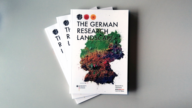 Three "The German Research Landscape" brochures are laying on a white table.