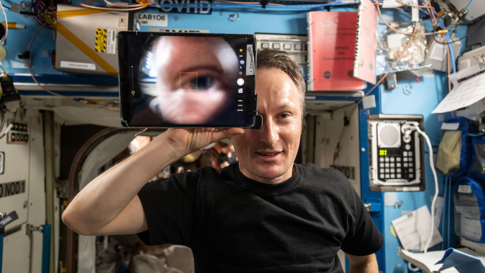 An astronaut looks through a mobile retina
