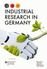 The cover of the brochure "Industrial Research in Germany". It depicts a robotic and a plant based hand shaking hands. Over it is written the brochure's title. On the bottom left there is the logo of the Federal Ministry of Education and Research. On the bottom right is the logo of "Research in Germany"
