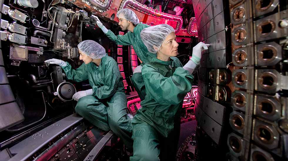 Max Planck Gesellschaft, Munich: three plasma physicists work at the centre  of the fusion research system  ASDEX Upgrade. 