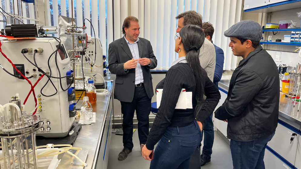 One part of the Brazilian innovators is standing in a lab listening to Prof. Nils Tippkötter who is explaining his researches in Bioprocess Engineering and Downstream Processing.