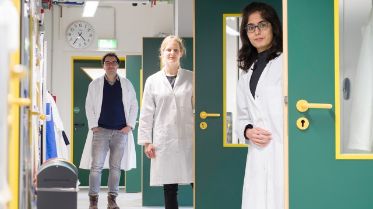 Three scientists at a corridor in one of Max Planck Institute Research centers