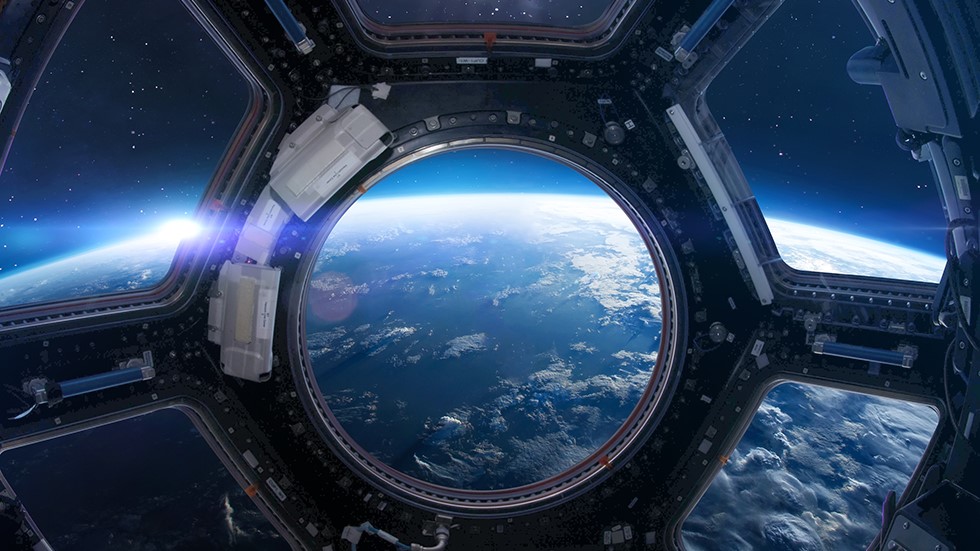 View of planet Earth through a porthole on the International Space Station (ISS).